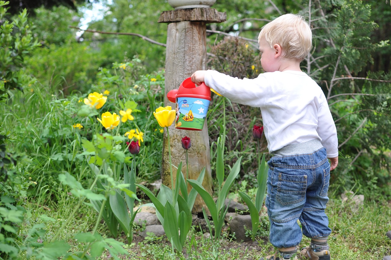 child watering a garden